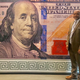 Designer Brian Thompson poses with his banknote.